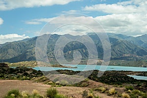 Blue lake surrounded by green hills