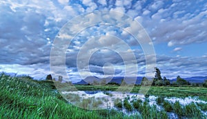 Blue Landscape with Dramatic Clouds Mountain and Water