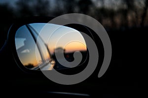 Blue landscape sunset reflect in mirror of car