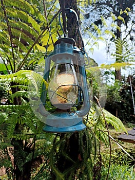 a blue lantern that is kept on the camping road