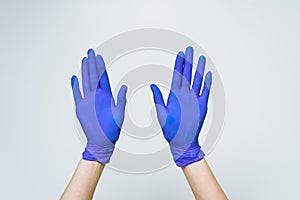 Blue Latex doctor Hand Gloves,Hand women five finger symbol with glove of doctor on blue background
