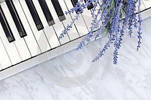 Blue lavender flowers on piano keys