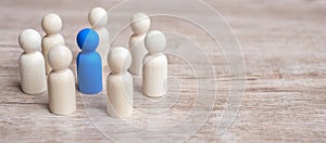 Blue leader businessman with circle of wooden men. leadership, business, team, and teamwork concept