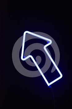 A blue LED arrow with a black background