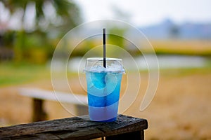 Blue lemon soda on wood table.