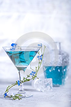 Blue lemonade in a glass with a flower