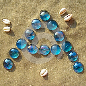Blue letters in the sand - A - vertical
