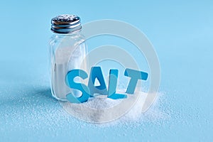 Blue letters spelling the word salt and salt shaker photo