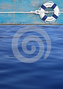 Blue lifebuoy on turquoise ship and water for maritime decoration or background for teamwork