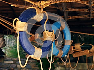 Blue lifebuoys are suspended under the roof in the interior of the beach cafe