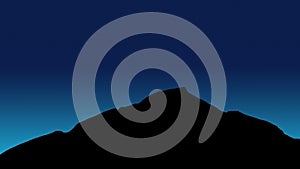 Blue light behind the mountain at night