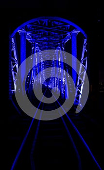 Blue light illuminated train bridge