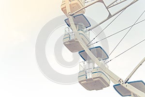 Blue, light, white, sky, ferris wheel. Ferris wheel and piece sunlight. Vintage style. Close-up