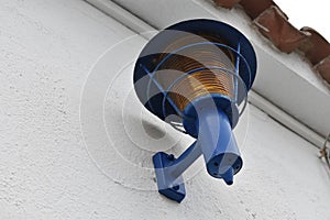 A BLUE LIGHT IN A WHITE WALL