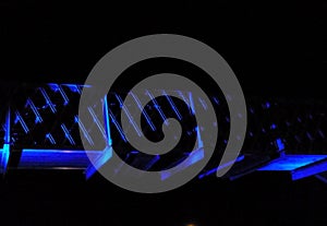 Blue lights on metal bridge walkway at night