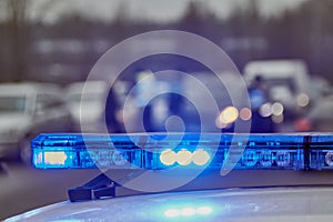 Blue lights of a police car at the scene of an accident