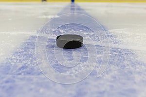 Blue line with puck on ice hockey rink