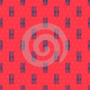 Blue line Ski and sticks icon isolated seamless pattern on red background. Extreme sport. Skiing equipment. Winter