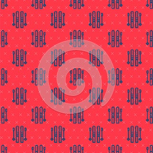 Blue line Ski and sticks icon isolated seamless pattern on red background. Extreme sport. Skiing equipment. Winter sports icon.