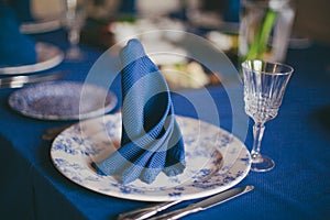 Blue linen napkin on dinner table photo