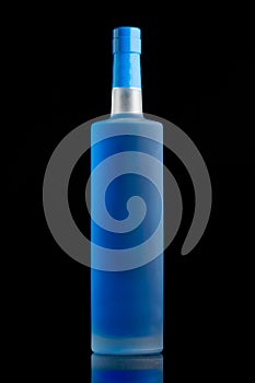 Blue liquid in a clear matte alcohol bottle