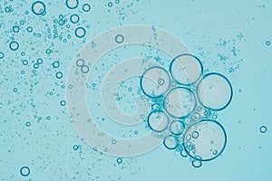 Blue liquid oil bubble macro texture background. Abstract beauty soap with omega vitamin image. Skin collagen fresh drop