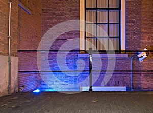 Blue lit entrance with camera