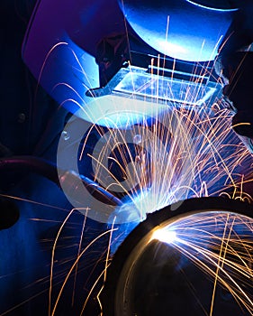 Blue lit MIG welder close photo