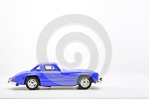 Blue little ancient model toy car isolated on background.