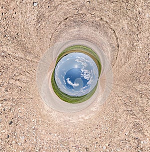 Blue little planet among white sand. Inversion of tiny planet transformation of spherical panorama 360 degrees. Spherical abstract