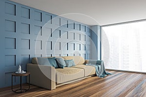 Blue living room corner with beige sofa