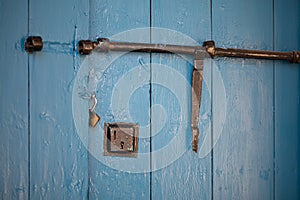 Blue locked door with open lockers close up still