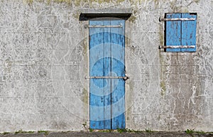 Blue locked door and window of grunge building