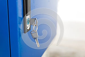 Blue locker and key chain in school gym. Modern metal cabinets and copyspace for your design