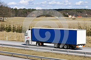 Blue lorry in countryside