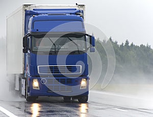 Blue Lorry on wet road