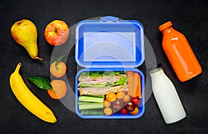 Blue Lunch Box with Vegetables and Fruits