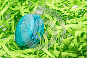 Blue macaron dessert on green serpantine background photo