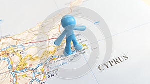 A blue man figurine standing over Ayia Napa on a map of Cyprus
