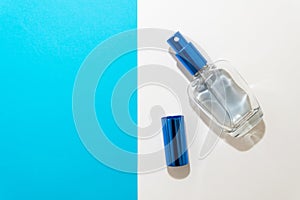 Blue man perfume bottle on a white and blue background. Blue perfume.