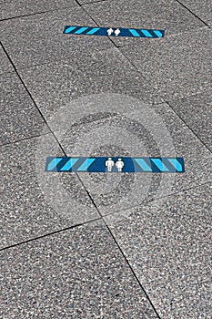 Blue marking indicating how much distance people should keep to be safe. 2.0 meters