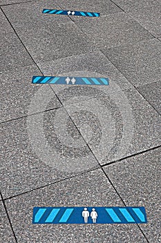 Blue marking indicating how much distance people should keep to be safe. 2.0 meters
