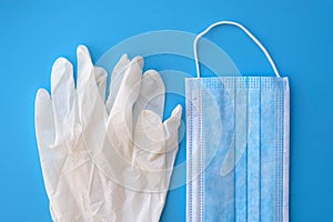 Blue medical face mask and disposable non-sterile gloves.