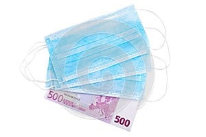 Blue medical face masks and 500 Euro banknote isolated on white background