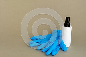 Blue medical gloves and a white bottle. Antiseptics and gloves