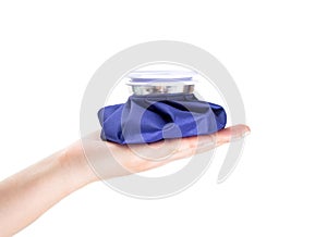 Blue medical ice bag on the palm, white background, isolate. Concept cold bag for pain relief, close-up