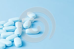 Blue medicine (painkiller) on blue