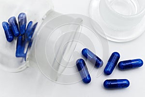 Blue medicine pils isolated on white background.