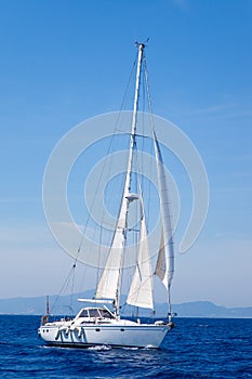 Blue Mediterranean sailboat sailing