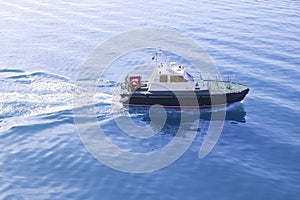 Blue Mediterranean Sea with pilots boat